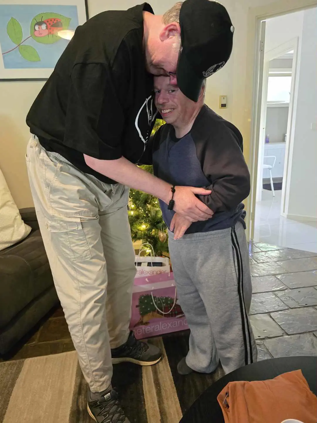 A man and boy standing next to each other.
