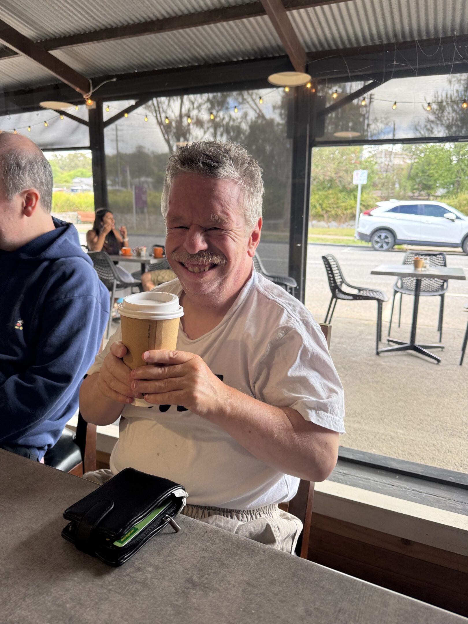 A man holding a cup of coffee in his hands.