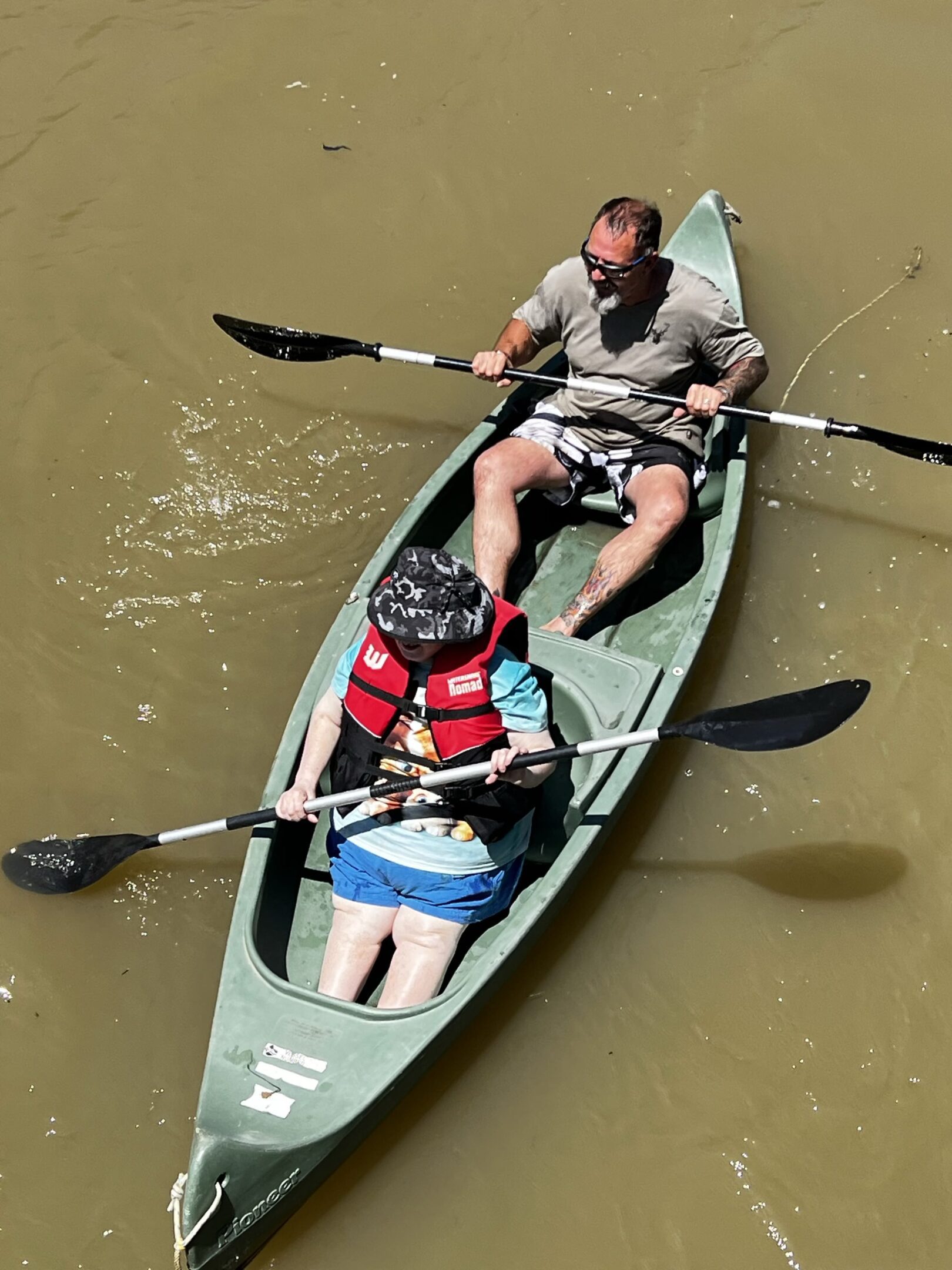 A man and woman in a canoe on the water.