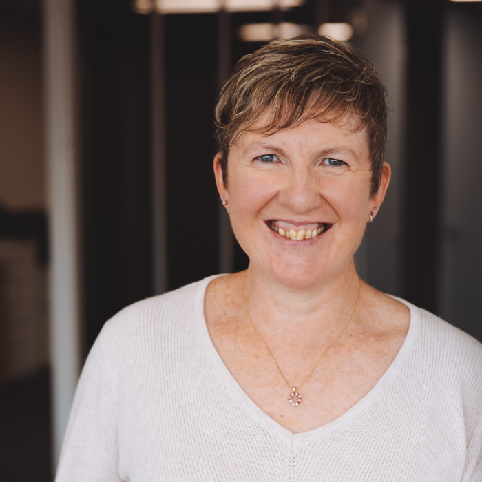 3 A woman with short hair is smiling for the camera.